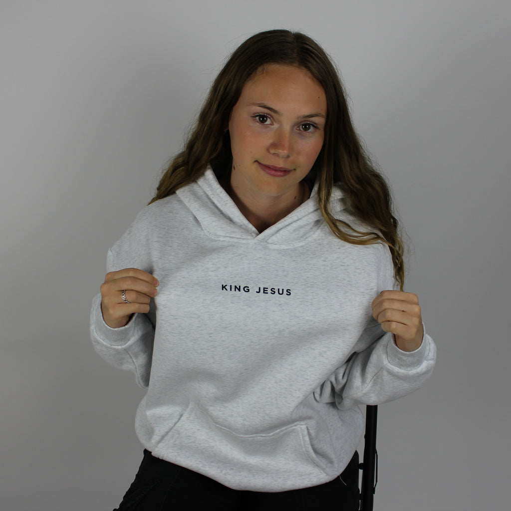 model wearing the heather grey King Jesus oversized Christian hoodie, showing the King Jesus front design and oversized fit.