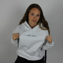 Load image into Gallery viewer, model wearing the heather grey King Jesus oversized Christian hoodie, showing the King Jesus front design and oversized fit.
